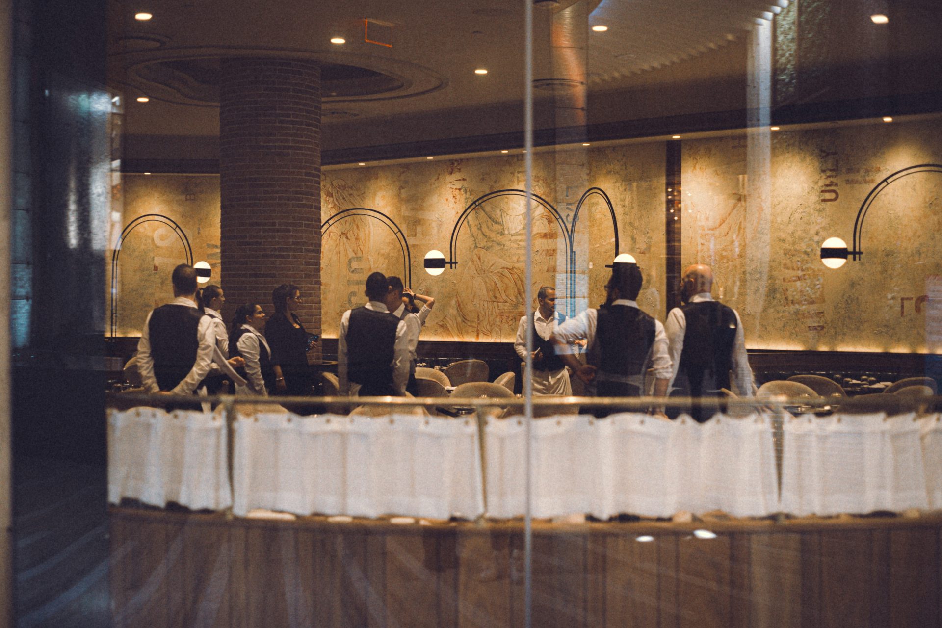 a group of people sitting at a table in a restaurant