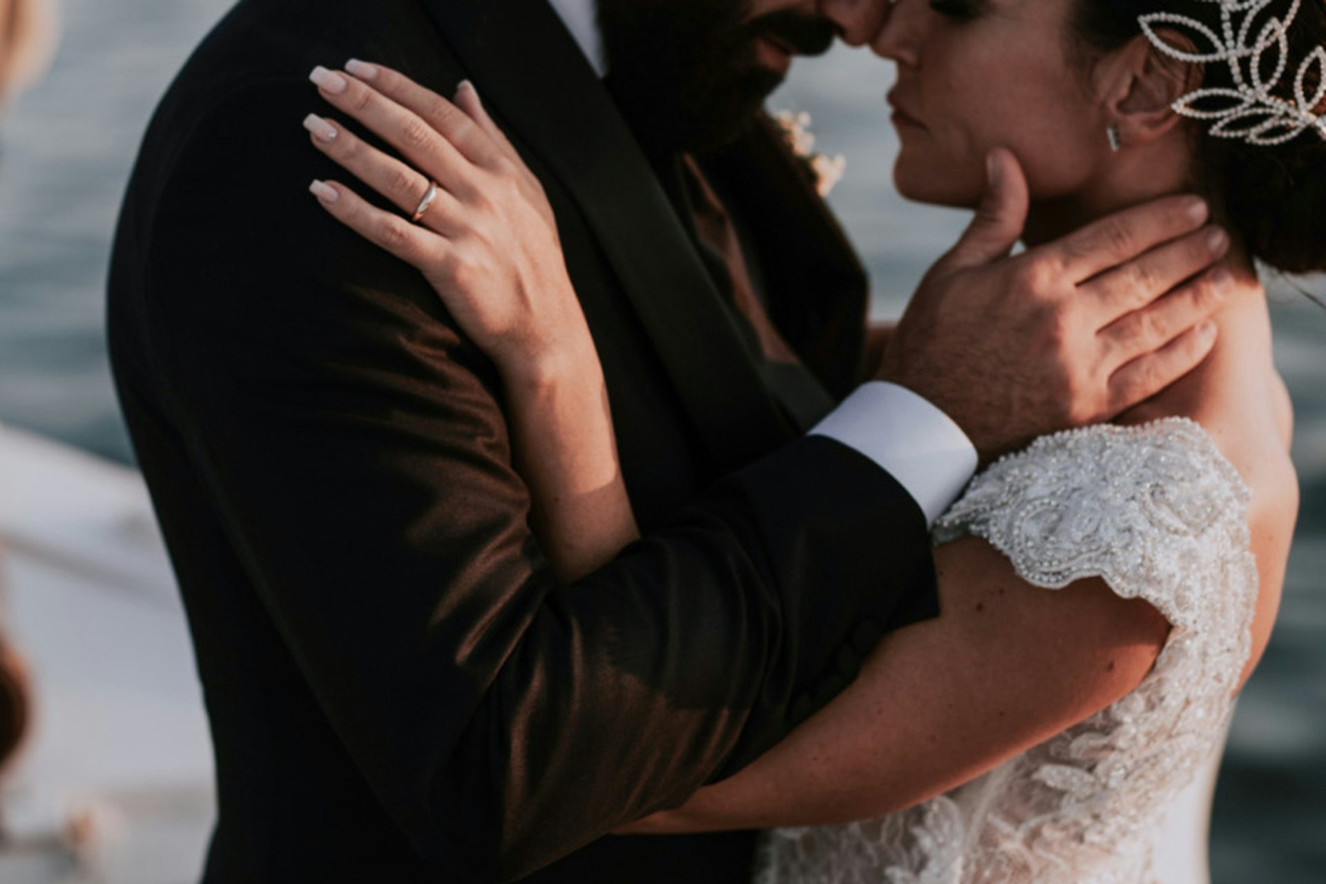 A bride and groom embracing on a boat